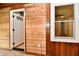 Bright living room features wood paneled walls, an entrance, and a white framed window at 2801 E Southport Rd, Indianapolis, IN 46227