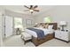 This bedroom boasts natural light, a large bed with stylish accents, and neutral colors for a restful ambiance at 2801 E Southport Rd, Indianapolis, IN 46227