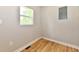 Small room with hardwood flooring and natural light from the window at 2801 E Southport Rd, Indianapolis, IN 46227