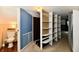 Finished attic hallway, adjacent to a full bathroom, has built-in shelving at 313 N 16Th Ave, Beech Grove, IN 46107