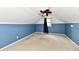 Finished attic with blue accent wall, dormer window and carpeted floor at 313 N 16Th Ave, Beech Grove, IN 46107