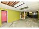 Basement with green walls, concrete floors, drop ceiling, and stairs at 313 N 16Th Ave, Beech Grove, IN 46107