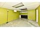 Basement with green walls, concrete floors, drop ceiling, and storage cabinets at 313 N 16Th Ave, Beech Grove, IN 46107