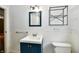 Bathroom with a blue vanity, and matching framed mirror over the sink at 313 N 16Th Ave, Beech Grove, IN 46107