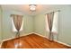 Bedroom with hardwood floors, light colored walls, curtains, and a ceiling light at 313 N 16Th Ave, Beech Grove, IN 46107