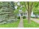 Charming home with a well-manicured front yard, mature trees, and inviting walkway at 313 N 16Th Ave, Beech Grove, IN 46107