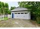 Detached garage with a white door, blue accent door, and driveway at 313 N 16Th Ave, Beech Grove, IN 46107