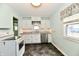 Kitchen featuring white cabinets, stainless steel dishwasher, and gray countertops at 313 N 16Th Ave, Beech Grove, IN 46107