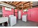 Laundry room with red brick walls and painted ceiling with a washing machine and dryer at 313 N 16Th Ave, Beech Grove, IN 46107