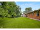 View of beautiful green backyard surrounded by lush green trees at 3235 Flintwood Dr, Columbus, IN 47203