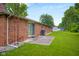 Exterior shot of backyard with sliding glass door and shed in the background at 3235 Flintwood Dr, Columbus, IN 47203