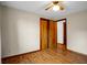 Bright bedroom features hardwood floors, ceiling fan, and spacious closet at 3235 Flintwood Dr, Columbus, IN 47203