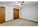 Bedroom featuring carpet, ceiling fan, and light blue striped wallpaper at 3235 Flintwood Dr, Columbus, IN 47203