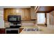A kitchen featuring wood cabinetry, stainless steel appliances, and a laminate countertop at 3235 Flintwood Dr, Columbus, IN 47203