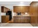 An open kitchen area with wood cabinets, a breakfast bar, and direct access to the living room at 3235 Flintwood Dr, Columbus, IN 47203