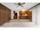 A cozy living room features wood paneling, carpet, and views into the adjacent kitchen at 3235 Flintwood Dr, Columbus, IN 47203
