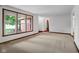 Carpeted living room featuring large windows that provide ample natural light at 3235 Flintwood Dr, Columbus, IN 47203