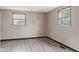 Cozy bedroom with durable gray floors, neutral walls and natural light from large windows at 330 S Green St, Brownsburg, IN 46112