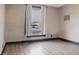 Bright bedroom with large window, neutral walls, and gray floors at 330 S Green St, Brownsburg, IN 46112
