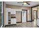 Open kitchen with white cabinetry, durable floors, and natural light from a back door at 330 S Green St, Brownsburg, IN 46112