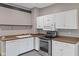 Well-lit kitchen featuring white cabinetry, updated appliances, and modern sink and faucet at 330 S Green St, Brownsburg, IN 46112