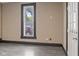 Bright living room with neutral walls, dark trim, durable gray floors and a large window at 330 S Green St, Brownsburg, IN 46112