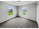 Bright bedroom featuring two windows offering views of the green lawn and pond, enhancing natural light at 3445 Brandenburg Blvd, Indianapolis, IN 46239