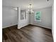 Dining room features stylish chandelier, wood floors, and a view of the front yard at 3445 Brandenburg Blvd, Indianapolis, IN 46239