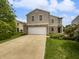 Inviting two-story home featuring a two car garage, brick accents, and manicured lawn at 3445 Brandenburg Blvd, Indianapolis, IN 46239