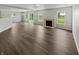Bright living room featuring wood floors, a fireplace, and multiple windows at 3445 Brandenburg Blvd, Indianapolis, IN 46239