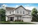 Charming two-story home features a gabled roof, a two-car garage, and beautifully landscaped front yard at 3695 Pinnacle Dr, Bargersville, IN 46106
