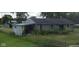 Cozy home with stone facade, shed, and large backyard with tall grass and a chainlink fence at 4631 Terrace Ave, Indianapolis, IN 46203