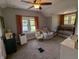 Well-lit bedroom featuring comfortable seating and a wooden crib by windows at 4740 Milton St, Coatesville, IN 46121