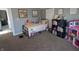 A cozy bedroom with carpet and neutral walls, decorated with personal items at 4740 Milton St, Coatesville, IN 46121