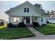 Charming front exterior with a covered porch, stone pillars, an American flag, and a well-manicured lawn at 4740 Milton St, Coatesville, IN 46121