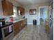 Traditional kitchen with wooden cabinets, stainless steel appliances, and neutral countertops at 4740 Milton St, Coatesville, IN 46121