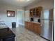 Spacious kitchen includes stainless steel refrigerator, wood cabinets, and gray countertops at 4740 Milton St, Coatesville, IN 46121