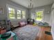 Bright playroom with hardwood floors, lots of light, play furniture, and a large decorative rug at 4740 Milton St, Coatesville, IN 46121