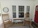 Inviting front porch with rocking chairs, a seasonal display, and a red front door at 4740 Milton St, Coatesville, IN 46121
