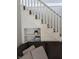 Close-up of a staircase with white railings and carpeted steps, including built-in shelving at 4740 Milton St, Coatesville, IN 46121
