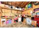 Unfinished basement space with workbench, storage shelves, and visible utilities, offering potential for customization and additional living area at 504 Broadway Ave, Arcadia, IN 46030