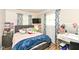 Bedroom features a grey bed frame, light pink bedding, blue throw blanket, and a desk with a mirror at 504 Broadway Ave, Arcadia, IN 46030