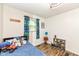 Well-lit bedroom with blue accents, plush toys, and creative decor at 504 Broadway Ave, Arcadia, IN 46030