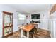 Cozy dining area featuring a wood table, modern chairs, and decorative wall accents with a tv at 504 Broadway Ave, Arcadia, IN 46030