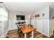 Bright dining space featuring a wooden table, four chairs, and a modern entertainment setup at 504 Broadway Ave, Arcadia, IN 46030