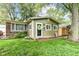 Charming single-story home features a vibrant green exterior, inviting front yard, and classic brick accents at 504 Broadway Ave, Arcadia, IN 46030