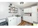 Convenient laundry room with modern washer and dryer, built-in cabinets, and shelving at 504 Broadway Ave, Arcadia, IN 46030