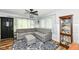 Bright and airy living space with a sectional sofa, natural light, and a decorative curio cabinet at 504 Broadway Ave, Arcadia, IN 46030
