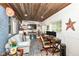 Cozy living room featuring wood plank ceilings, a sofa, and a workstation at 504 Broadway Ave, Arcadia, IN 46030