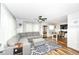Spacious living area featuring neutral decor, a ceiling fan, and an adjacent dining space at 504 Broadway Ave, Arcadia, IN 46030